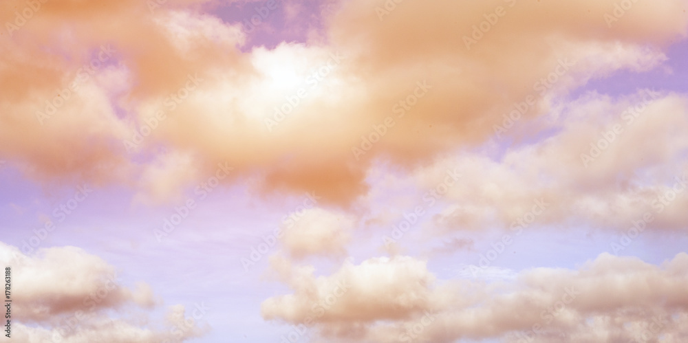 Pastel coloured romantic sky with white clouds