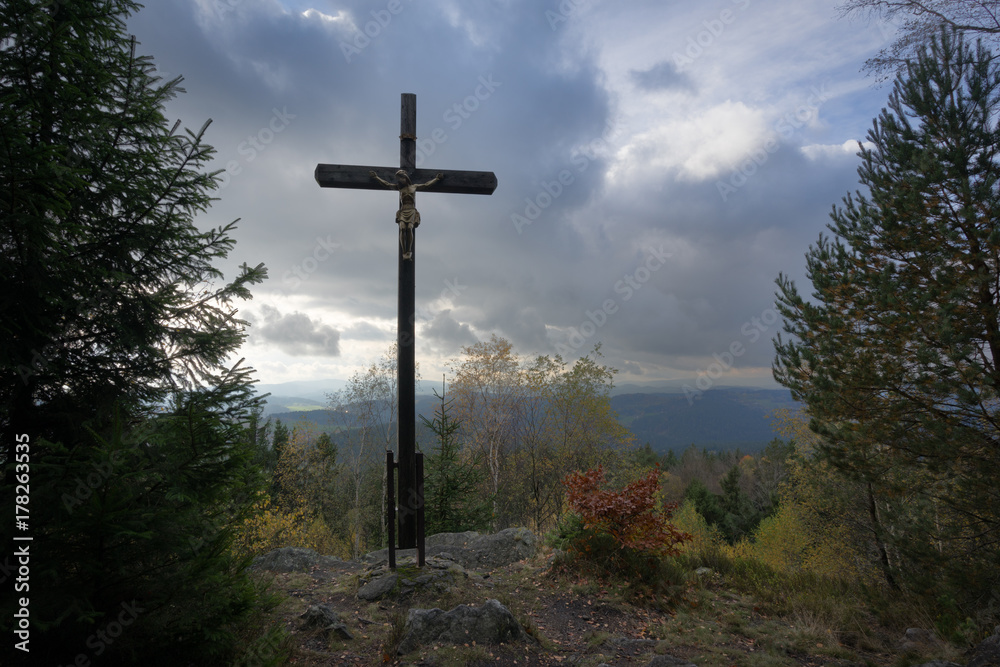 Crucifix high above sea level, surrounded by trees and clouds. Crucifix high above sea level, surrounded by trees and clouds.