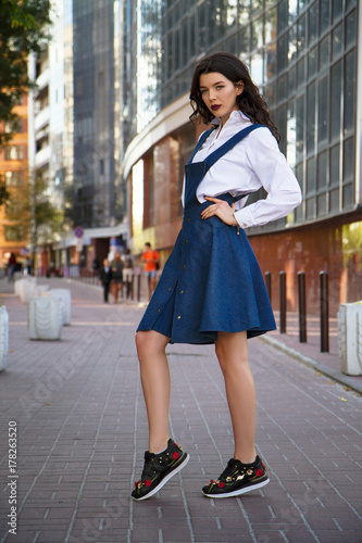Fashionable beautiful girl in a denim dress