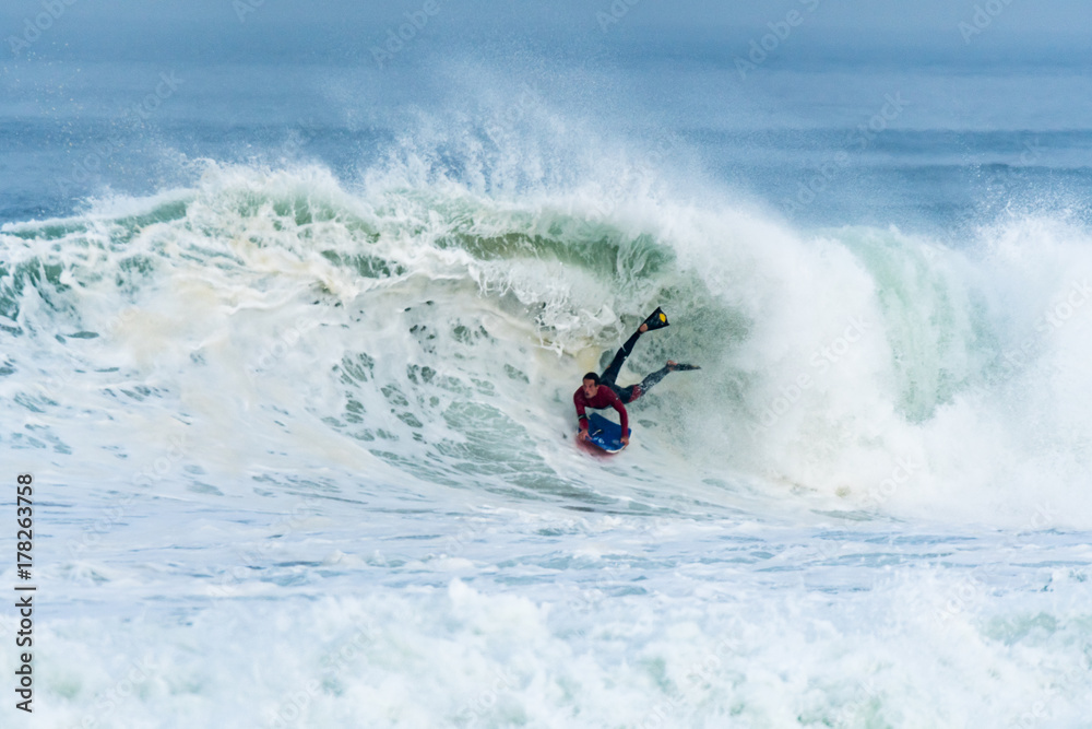 Bodyboarder surfing ocean wave