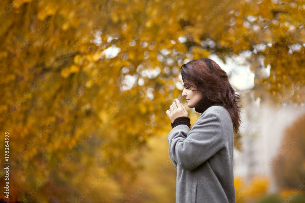 Beautiful elegant woman in autumn park. Fall yellow garden background Beautiful elegant woman in autumn park. Fall yellow garden background