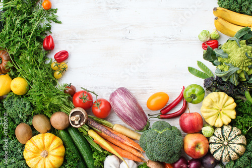 Fototapeta Naklejka Na Ścianę i Meble -  Above view of fresh raw vegetables, fruits and herbs on wooden white background, copy space for text, selective focus