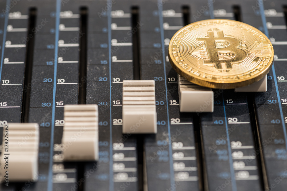 Bitcoin coin on the sound mixer console. Concept idea Bitcoin coin on the sound mixer console. Concept idea