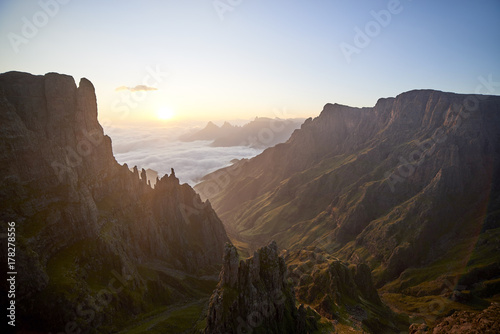 Sunrise over a breathtaking, wild and spired rocky mountain tops. photo