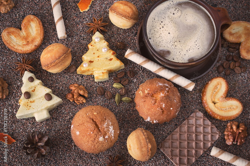 Fototapeta premium New Year, Christmas treats, sweets. New year, Christmas treats, sweets. A Cup of hot chocolate, cookies, striped candy, spices from anise, cardamom, and coffee. Delicious homemade Christmas cookies.