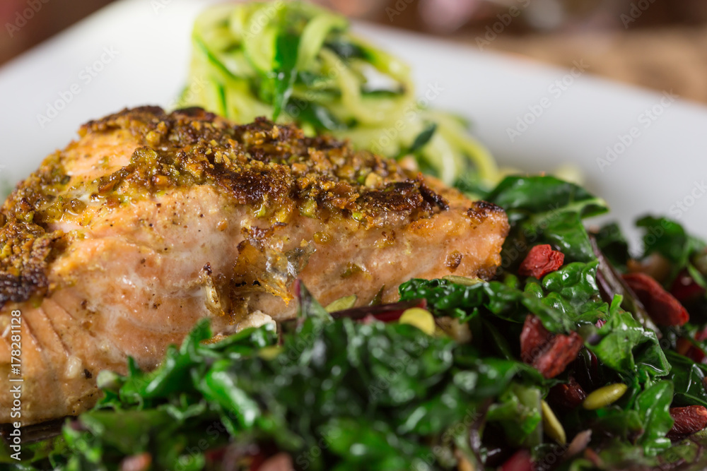 Pistachio Crusted Grilled Wild Salmon Fillet on a bed of Collard Greens and Zoodles (zucchini Noodle). Pistachio Crusted Grilled Wild Salmon Fillet on a bed of Collard Greens and Zoodles (zucchini Noodle).