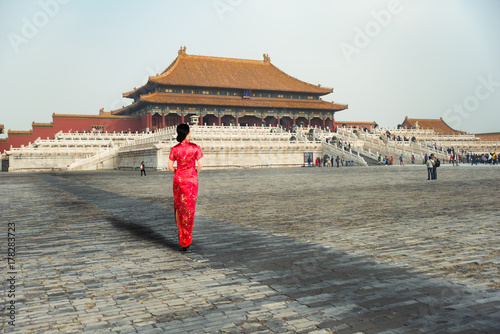 Asian young woman in old traditional Chinese dresses in the Forbidden city in Beijing, China.