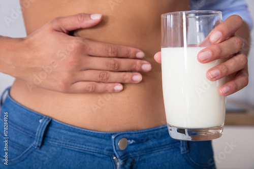 Woman's Hand Holding Glass Of Milk