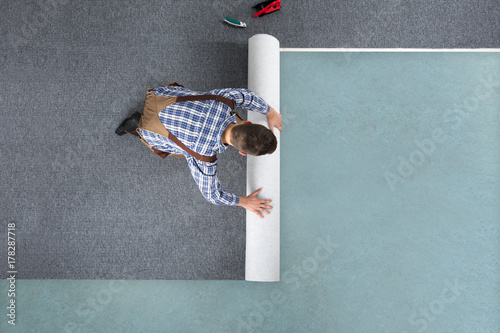 Photography Young Male Worker In Overalls Rolling Carpet