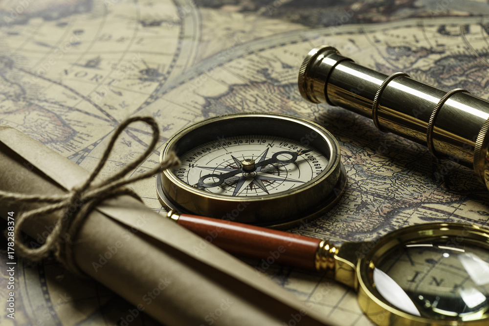 Retro compass with old map and spyglass