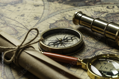 Retro compass with old map and spyglass