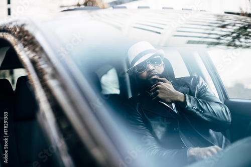 Stylish black man in his car photo