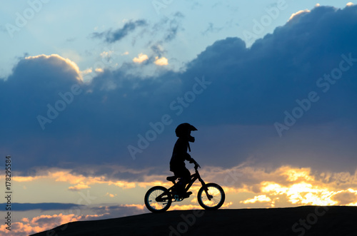 Boy Riding BMX bike at sunset