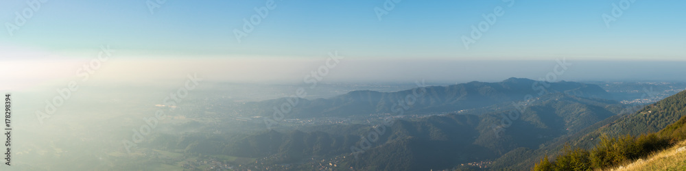 Morning landscape on the Padana plain with high pollution and humidity in the air. Panorama from Linzone Mountain, Bergamo, Italy