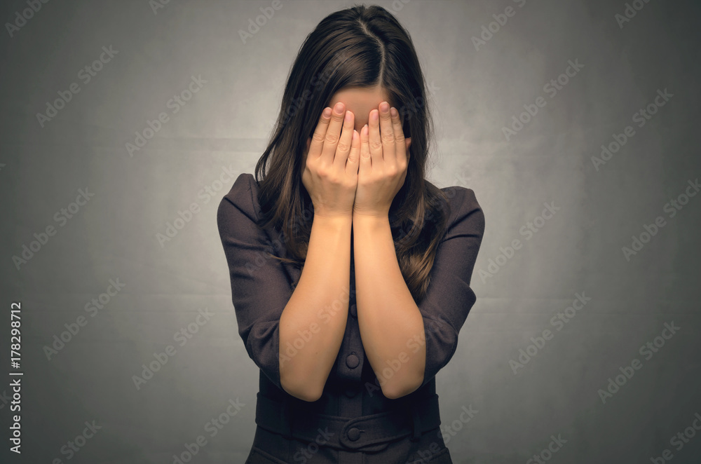 Crying young woman isolated. Young girl crying covered her face with her hands. Depression. Crying young woman isolated. Young girl crying covered her face with her hands. Depression.