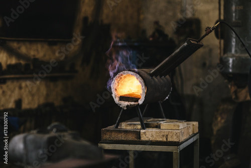 Flames coming out of a blacksmith's gas forge