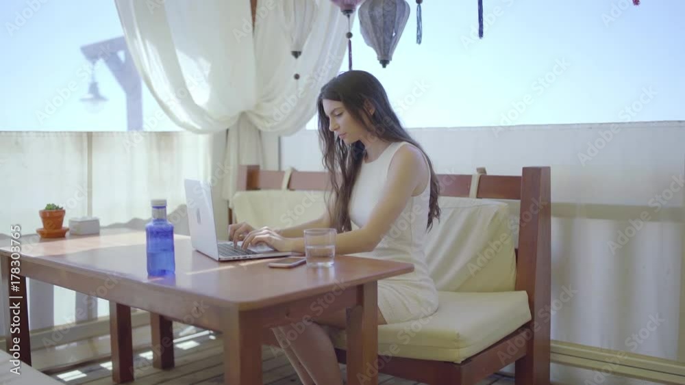 Beautiful woman using laptop in restaurant Beautiful woman using laptop in restaurant