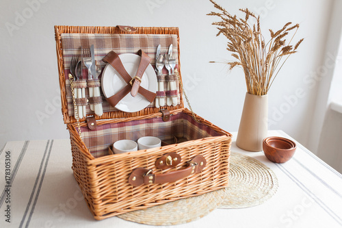 Set for a picnic in a brown basket
