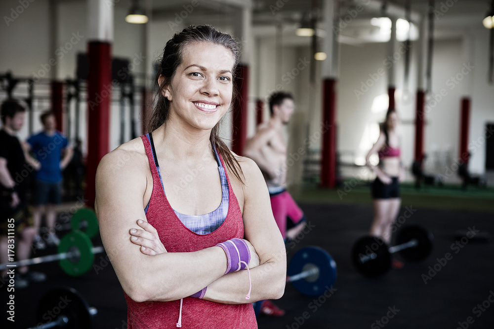 Fit Woman With Arms Crossed Standing In Fitness Center Fit Woman With Arms Crossed Standing In Fitness Center