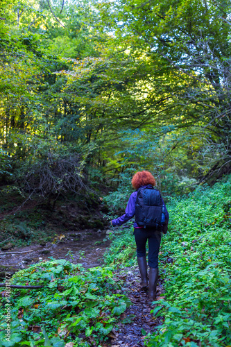 Hiker woman on a trail by the river