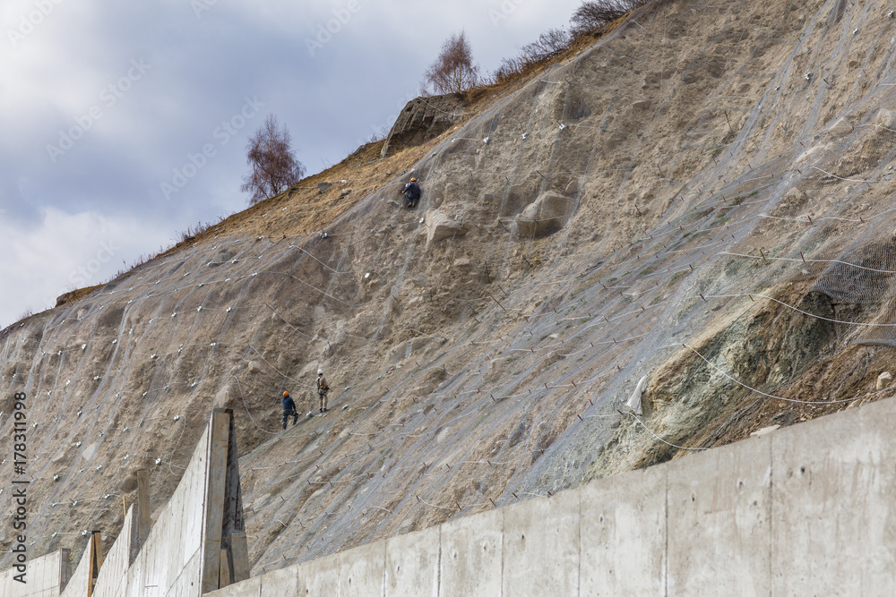 mesh for slope strengthening,workers work in the mountains mesh for slope strengthening,workers work in the mountains
