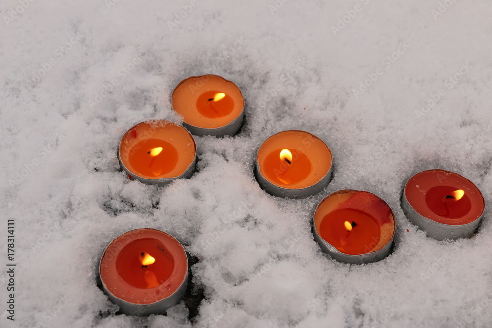 bright multicolored candles burn in the snow bright multicolored candles burn in the snow