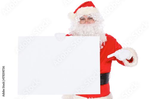 Santa Claus pointing on blank white wall, advertisement banner with copy space. Isolated on white background © volha_r