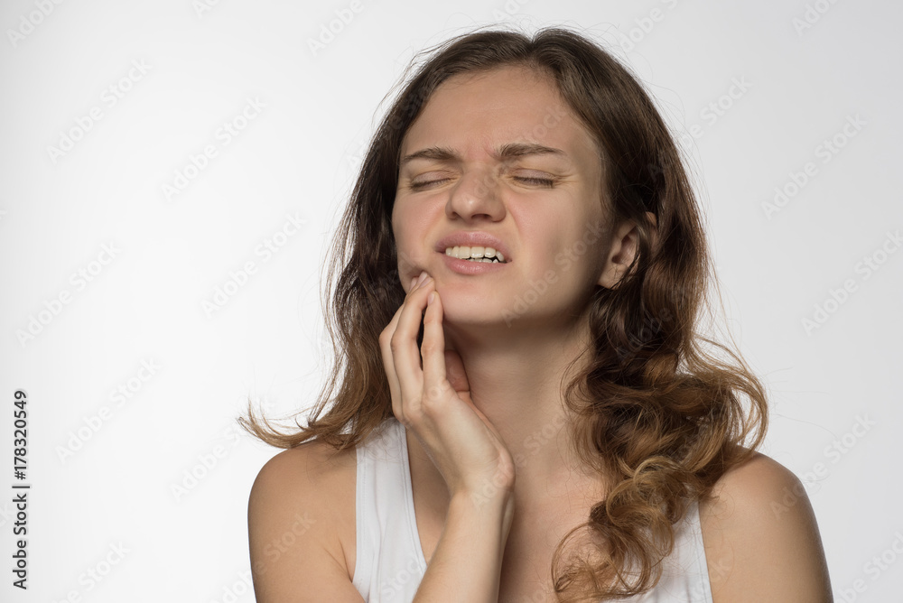 Young beautiful giirl on white background with toothache Young beautiful giirl on white background with toothache
