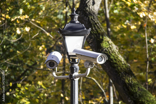 Security cctv cameras in the park autumn background