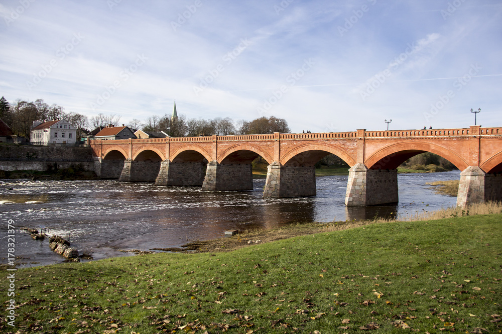 old Brick bridge across the River Venta in the city of Kuldiga Latvia
