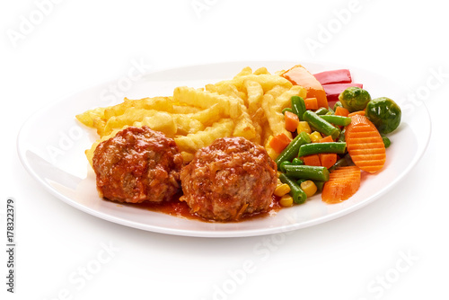 Meatballs in tomato sauce with potatoes fries and vegetables, isolated on white background