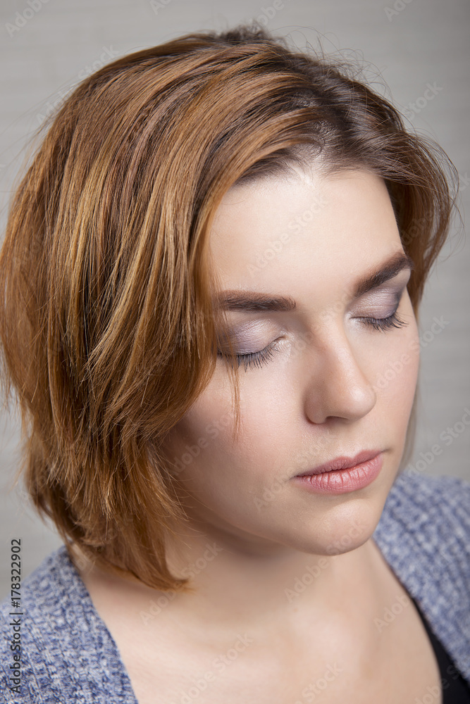 Portrait of a girl with evening makeup on the eyes closed close-up