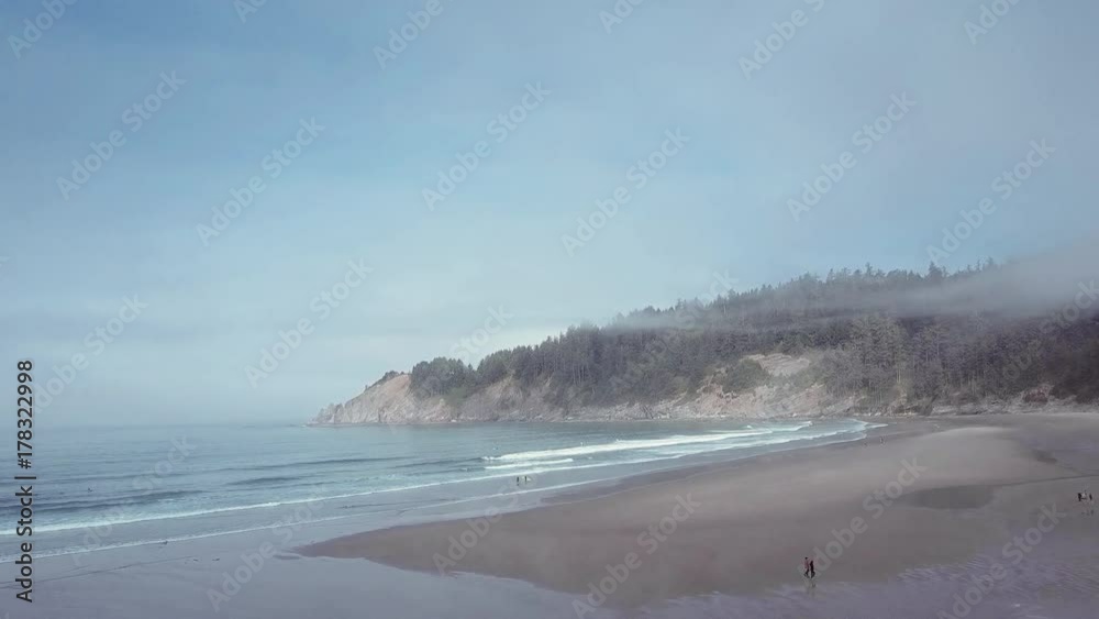 Aerial shot of beach on Oregon coast with cliffs and ocean waves Aerial shot of beach on Oregon coast with cliffs and ocean waves
