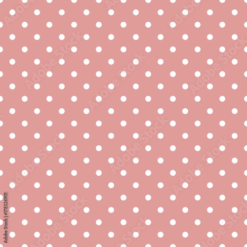 Seamless pattern of small, white polka dots on a pink background