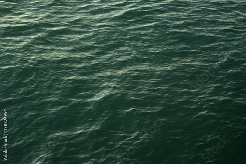 background, texture: sea water surface in evening illumination