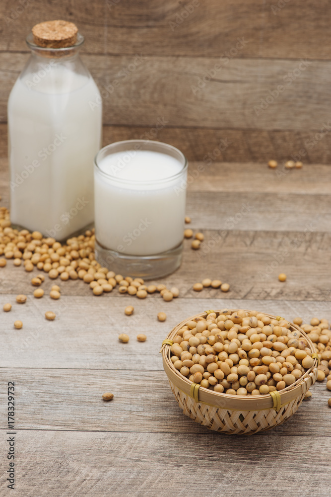 Bottle of soy milk and soybean on wooden table Bottle of soy milk and soybean on wooden table