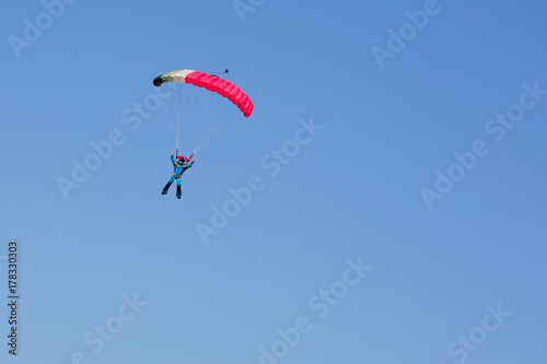  parachutist on background clear blue sky