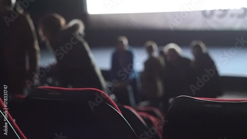 People leave auditorium during the movie performance. photo