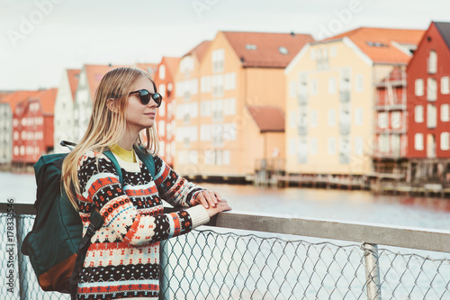 Young woman traveling in Trondheim city Norway vacations weekend Lifestyle fashion outdoor scandinavian houses landmarks architecture on background