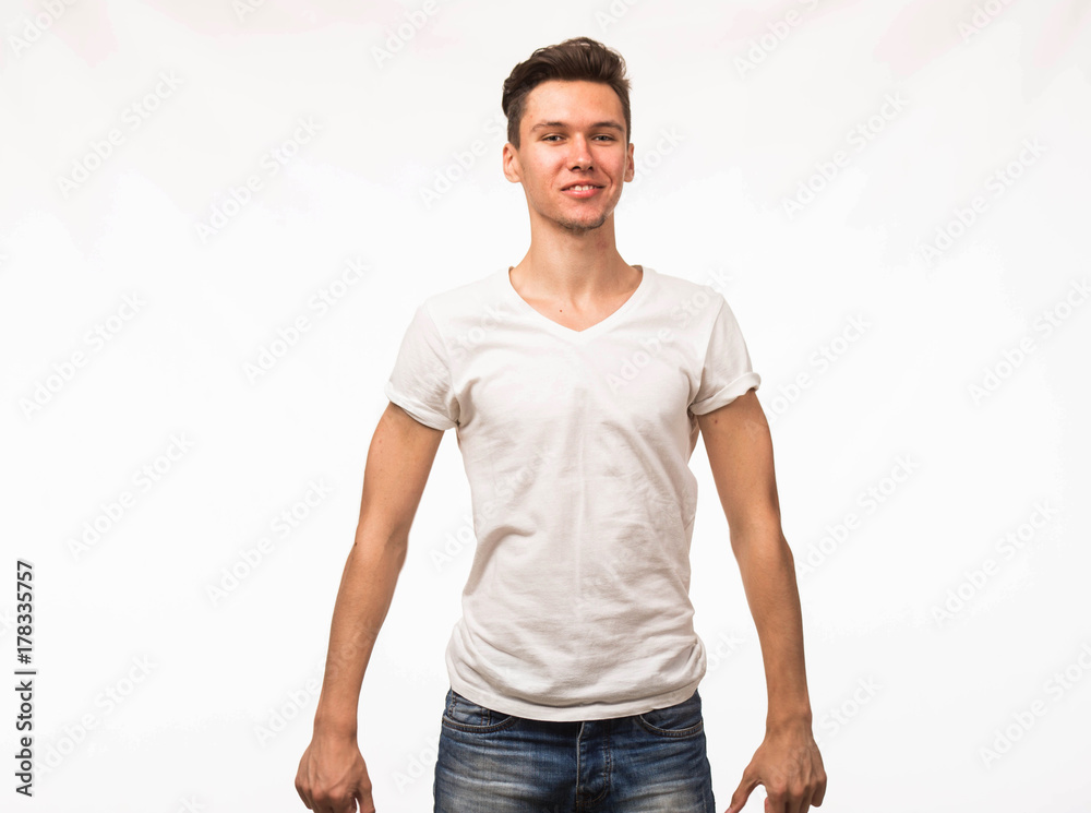 Fototapeta premium Young happy man portrait of a confident businessman showing by hands on a gray background. Ideal for banners, registration forms, presentation, landings, presenting concept.