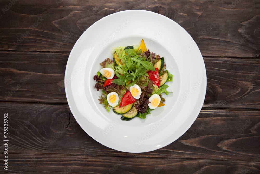 salad greens of cabbage broccoli, pumpkin puree, and quail eggs on a wooden black table, and a centimeter ribbon, healthy food, fitness menu salad greens of cabbage broccoli, pumpkin puree, and quail eggs on a wooden black table, and a centimeter ribbon, healthy food, fitness menu