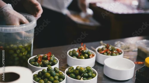 Wallpaper Mural Cooks spread the olives in bowls close up Torontodigital.ca