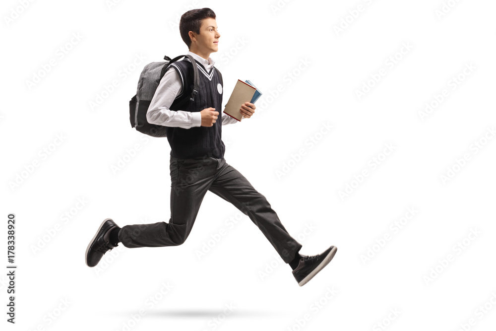 Teenage student with a backpack and books in mid-air Teenage student with a backpack and books in mid-air