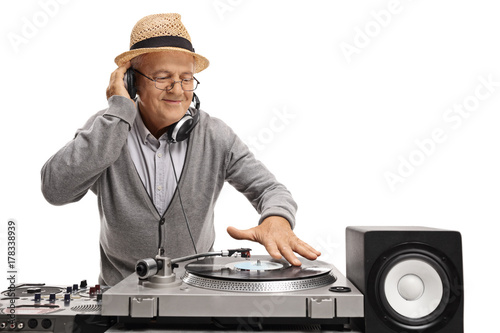 Old DJ playing music on a turntable