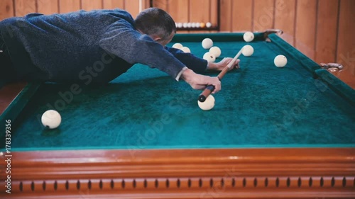 Wallpaper Mural Man rolls the ball into the hole close up Torontodigital.ca