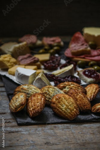 a variety of snacks (antipasto) - cheese, olives, pate, jam, Madeleine and more