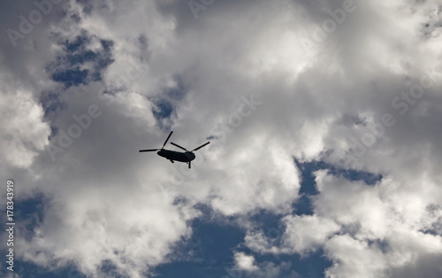 Helicopter flying in cloudy sky