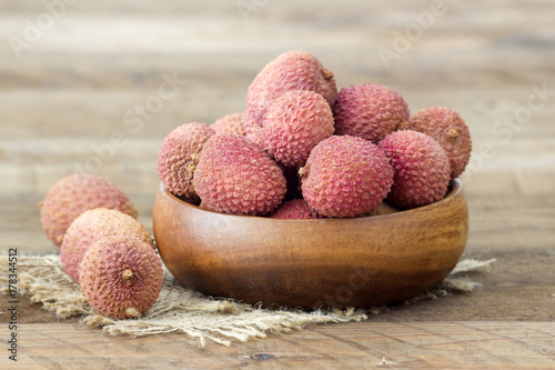 fresh lychees in a bowl  on wooden background