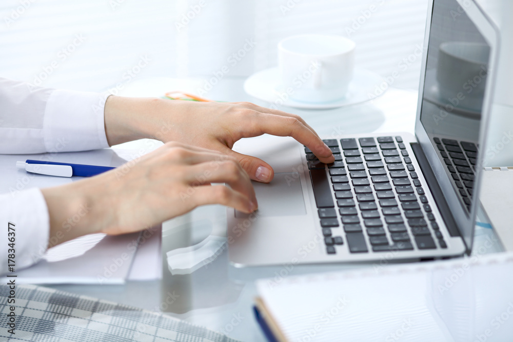 Close up of business woman hands typing on laptop computer Close up of business woman hands typing on laptop computer