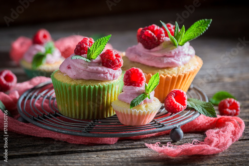 Homemade raspberry cupcake with berries and pink cream